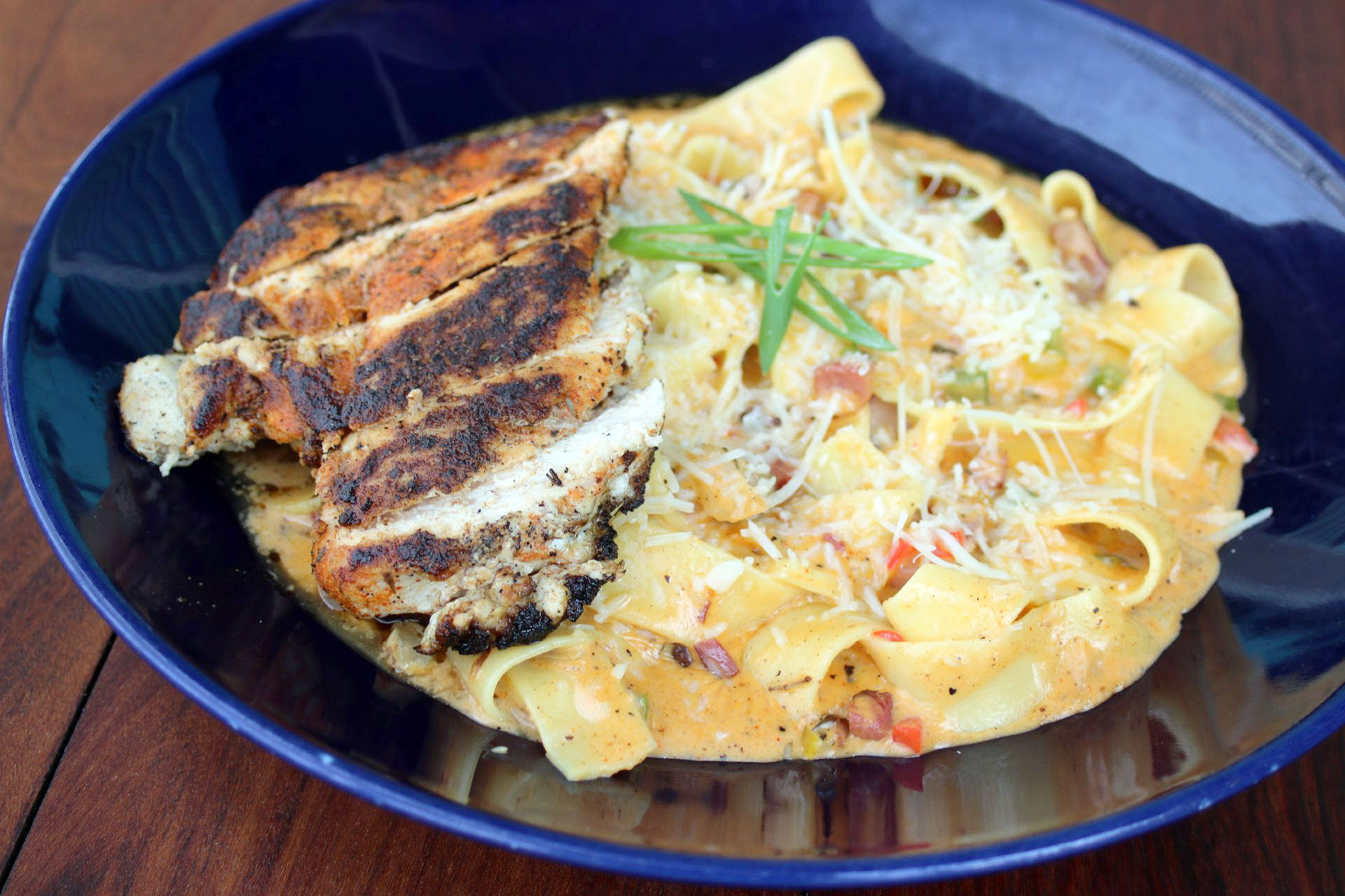 blackened chicken with spicy housemade tasso ham over pappardelle pasta
