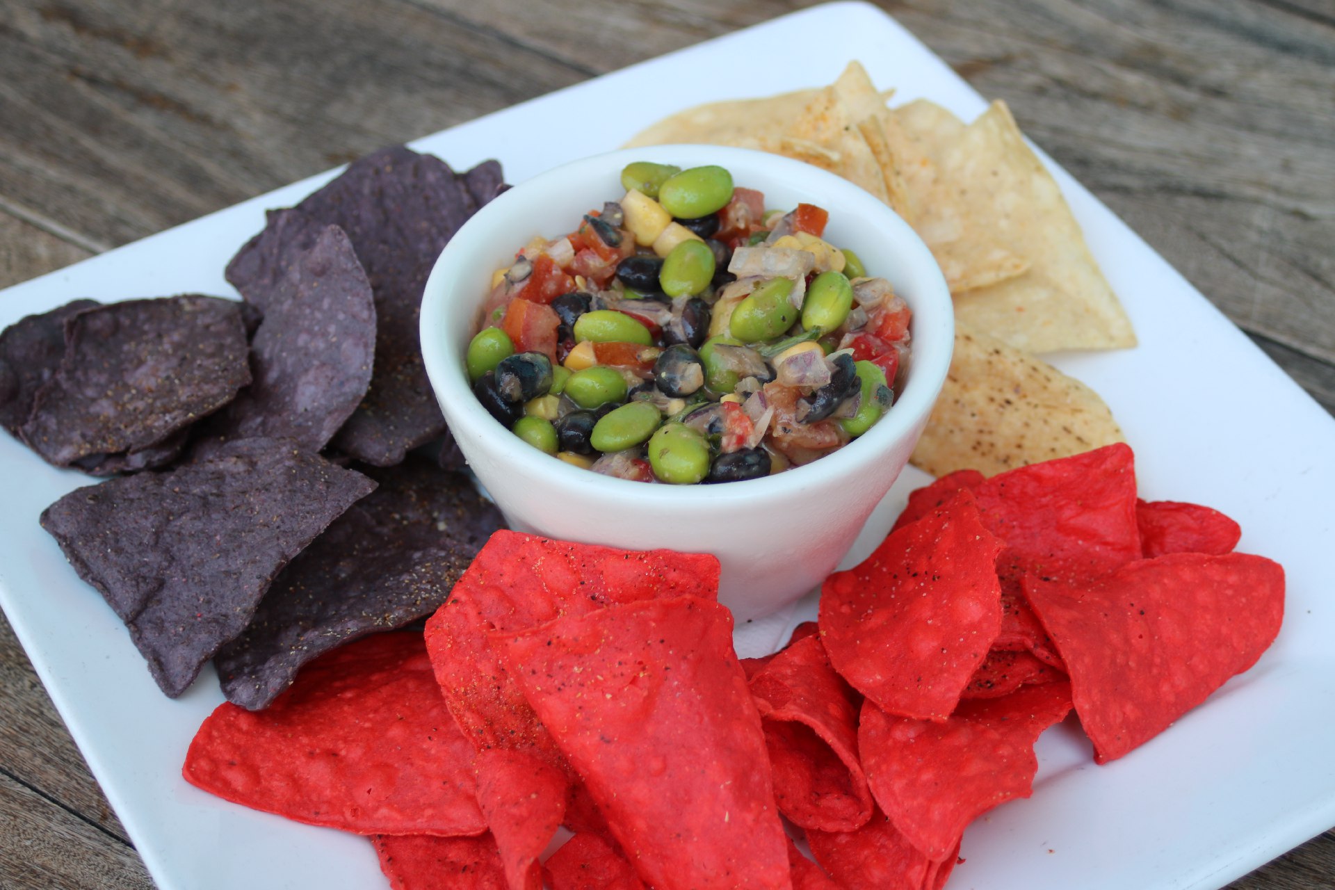 black beans, edamame, corn, red onion, roma tomatoes with corn tortilla chips.